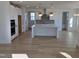 Modern kitchen with white cabinets, island, and stainless steel appliances at 1109 Prominence Dr., Homesite 17, Durham, NC 27712