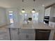 Kitchen island with farmhouse sink and modern pendant lighting at 1109 Prominence Dr., Homesite 17, Durham, NC 27712