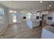 Open concept kitchen with island, hardwood floors, and breakfast nook at 1109 Prominence Dr., Homesite 17, Durham, NC 27712