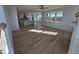 Bright living area with hardwood floors, open concept kitchen, and natural light at 1109 Prominence Dr., Homesite 17, Durham, NC 27712