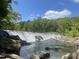 Scenic waterfall flowing into a river at 1109 Prominence Dr., Homesite 17, Durham, NC 27712