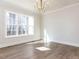 Sun-filled Living Room features large windows, hardwood floors, recessed lights, and decorative ceiling at 51 Autumn Gate St, Pittsboro, NC 27312