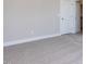 Neutral bedroom featuring carpeted floors and a white door at 81 Autumn Gate St, Pittsboro, NC 27312