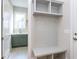 Inviting mudroom featuring bench seating with shelving and adjacent laundry room entrance at 81 Autumn Gate St, Pittsboro, NC 27312