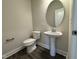 Clean bathroom with pedestal sink and oval mirror at 99 Mapledale Ct, Benson, NC 27504