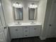 Double vanity bathroom with white cabinets and quartz countertops at 99 Mapledale Ct, Benson, NC 27504
