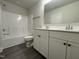 Clean bathroom with double vanity, tub, and updated finishes at 99 Mapledale Ct, Benson, NC 27504