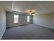 Large bedroom with ceiling fan and carpet, plus two windows at 99 Mapledale Ct, Benson, NC 27504