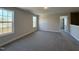 Spacious bedroom featuring two windows and access to hallway at 99 Mapledale Ct, Benson, NC 27504