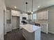 Modern kitchen with white cabinets and an island at 99 Mapledale Ct, Benson, NC 27504