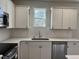 Modern kitchen featuring white cabinets and quartz countertops at 99 Mapledale Ct, Benson, NC 27504