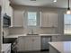 Modern kitchen featuring white cabinets and quartz countertops at 99 Mapledale Ct, Benson, NC 27504
