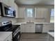 Modern kitchen with stainless steel appliances and white cabinets at 99 Mapledale Ct, Benson, NC 27504