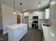 Modern kitchen with white cabinets and an island at 99 Mapledale Ct, Benson, NC 27504