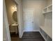 Convenient laundry room with built-in shelving and rod at 99 Mapledale Ct, Benson, NC 27504