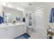 Bright bathroom with double vanity sinks, a shower-tub combination and modern fixtures at 516 Marthas View Way, Rolesville, NC 27587