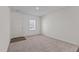 Bright entryway with neutral carpet and wood-look flooring at 7211 Pilatus Ave, Spring Hope, NC 27882