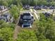 Aerial view of a home with a private backyard pool nestled among mature trees at 7417 Dover Hills Dr, Wake Forest, NC 27587