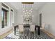 Chic dining room with modern light fixture, accent wall, and striped rug at 7417 Dover Hills Dr, Wake Forest, NC 27587