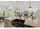 Stylish kitchen island featuring a sink, and sleek design with an open concept to the living space at 7417 Dover Hills Dr, Wake Forest, NC 27587