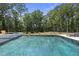 Stunning backyard pool and hot tub, surrounded by lush greenery, providing a luxurious and private outdoor oasis at 7417 Dover Hills Dr, Wake Forest, NC 27587