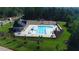 Aerial view of community pool with lounge chairs, fountain, ample parking, and landscaping at 7417 Dover Hills Dr, Wake Forest, NC 27587
