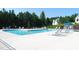 Community pool with a splash fountain, surrounded by lounge chairs and landscaping at 7417 Dover Hills Dr, Wake Forest, NC 27587