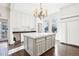 White kitchen with marble island and chandelier at 728 W Davis St, Burlington, NC 27215