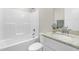 Bright bathroom featuring granite countertop, tub-shower combo, white cabinets and modern fixtures at 98 Linda St, Princeton, NC 27569