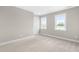 Neutral bedroom with two windows and plush carpet at 98 Linda St, Princeton, NC 27569