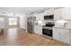 Open-concept kitchen with stainless steel appliances that adjoins the living room at 98 Linda St, Princeton, NC 27569