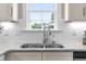 Stylish kitchen sink with a view to outside, granite countertops, and white cabinets at 98 Linda St, Princeton, NC 27569