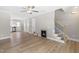 Open-concept living room with hardwood floors, fireplace, and staircase to the upper level at 98 Linda St, Princeton, NC 27569
