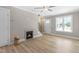 Bright living room boasts a fireplace, ceiling fan, and natural light from the window at 98 Linda St, Princeton, NC 27569