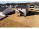 Aerial view of the back of a two-story home featuring a screened-in porch and spacious backyard at 370 Fast Pitch Ln, Four Oaks, NC 27524