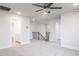 Carpeted loft area with staircase, railing, ceiling fan and access to multiple rooms at 370 Fast Pitch Ln, Four Oaks, NC 27524