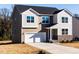 Beautiful two-story home with a two-car garage and landscaped front yard and manicured lawn at 370 Fast Pitch Ln, Four Oaks, NC 27524