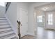 Entryway with staircase, white doors, modern flooring, and access to other rooms of the home at 370 Fast Pitch Ln, Four Oaks, NC 27524