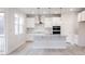 Contemporary white kitchen with a large window, stainless steel hood, and sleek countertops at 370 Fast Pitch Ln, Four Oaks, NC 27524