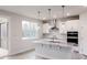 Bright kitchen featuring an island with seating, modern appliances, and access to the outdoors at 370 Fast Pitch Ln, Four Oaks, NC 27524