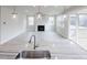 Spacious kitchen with island sink overlooking an open-concept living area with fireplace at 370 Fast Pitch Ln, Four Oaks, NC 27524