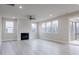 Bright and airy living room with a fireplace, multiple windows, and wood-look flooring at 370 Fast Pitch Ln, Four Oaks, NC 27524
