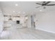 Open-concept living area showcases a modern kitchen and a staircase, perfect for a connected living experience at 370 Fast Pitch Ln, Four Oaks, NC 27524