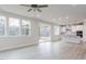 Bright living space featuring a modern kitchen, large windows, and sliding doors to an outdoor deck at 370 Fast Pitch Ln, Four Oaks, NC 27524