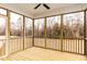 Screened in porch featuring wood flooring and views of the backyard at 370 Fast Pitch Ln, Four Oaks, NC 27524