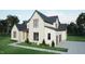 Beautiful two-story home featuring a brick and clapboard facade with black frame windows and a two car garage at 3612 Bailey Meadows Drive Dr, Wake Forest, NC 27587