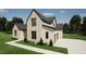 Beautiful two-story home featuring a brick and clapboard facade with black frame windows and a two car garage at 3612 Bailey Meadows Drive Dr, Wake Forest, NC 27587