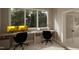 Bright home office with built-in desk, dual monitors and large window overlooking lush greenery at 3612 Bailey Meadows Drive Dr, Wake Forest, NC 27587
