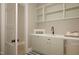 Well-lit laundry room with modern cabinets, sink, and ample counter space for folding laundry at 3612 Bailey Meadows Drive Dr, Wake Forest, NC 27587