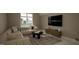 Comfortable living room showcasing a large sectional sofa, entertainment center and a large window at 3612 Bailey Meadows Drive Dr, Wake Forest, NC 27587